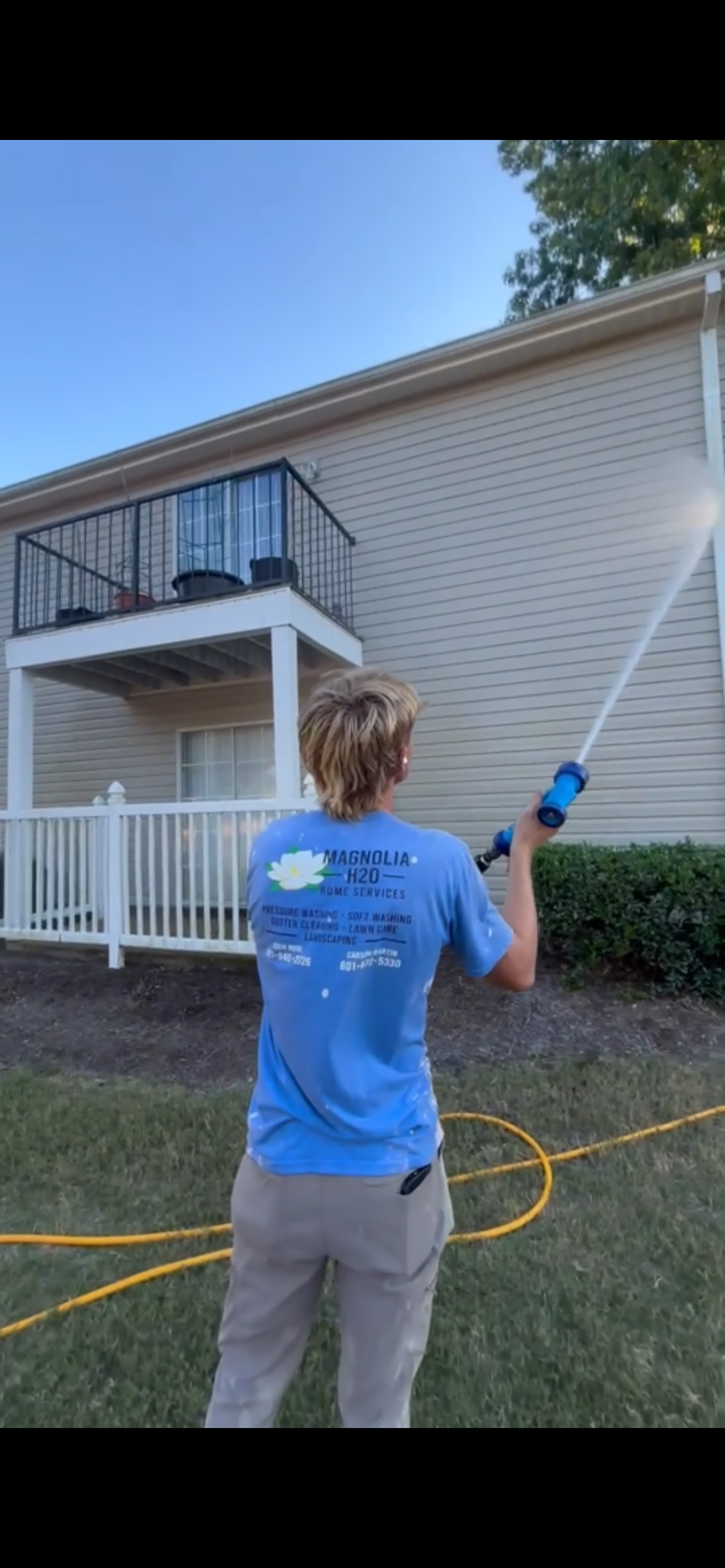 Magnolia H2O technician pressure washing a house